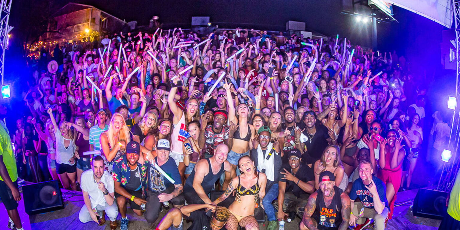 Crowd of grads with hands up at a Myrtle Beach Senior Week concert