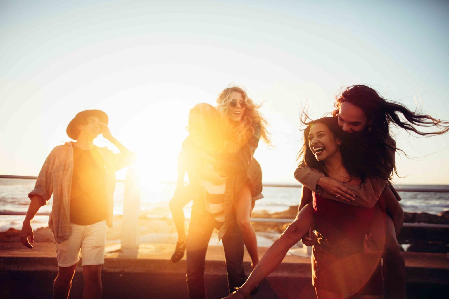 Friends laughing and celebrating on the Myrtle Beach oceanfront at sunset