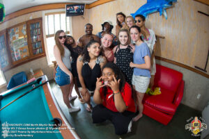 Senior Week friends posing together inside a North Myrtle Beach beach house