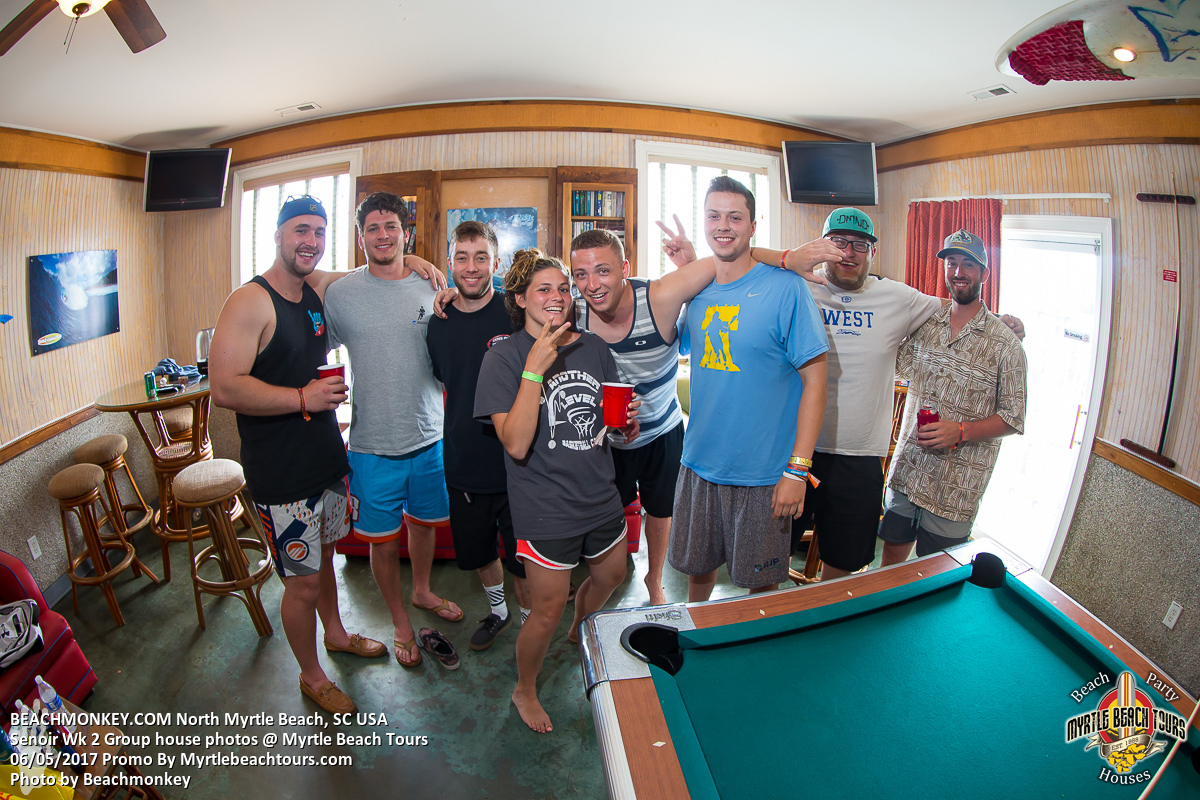Senior Week friends posing by a pool table in a North Myrtle Beach rental