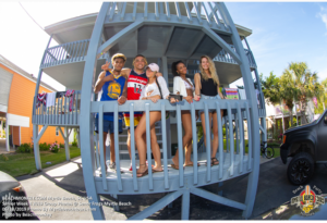 Senior Week friends posing under a North Myrtle Beach stilt house