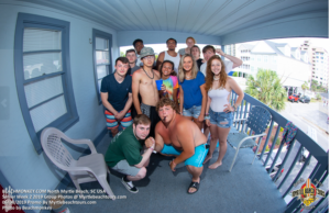Senior Week group posing on a balcony in North Myrtle Beach