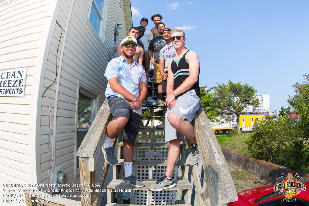 Senior Week group seated on the outdoor stairs of a North Myrtle Beach rental