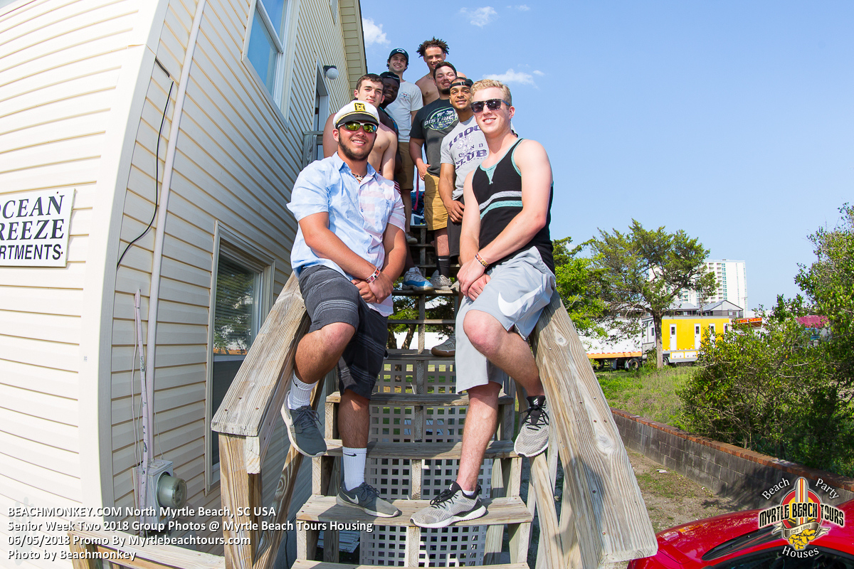 Senior Week group seated on the outdoor stairs of a North Myrtle Beach rental