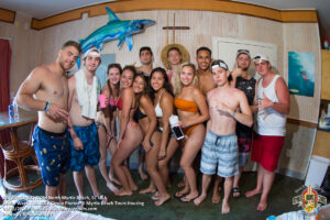 Senior Week group posing inside a North Myrtle Beach rental house