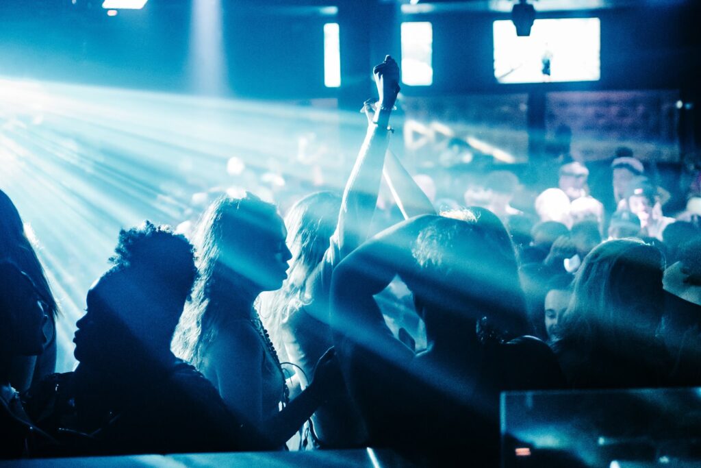 Senior Week crowd dancing under bright laser lights at a Myrtle Beach theme party